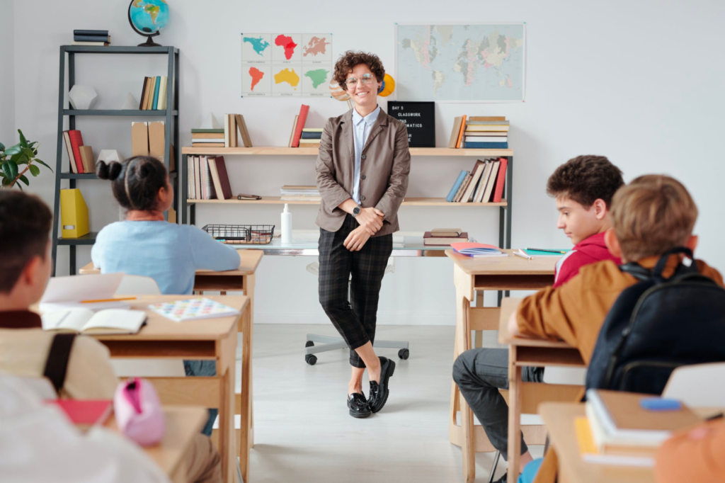 A foreign teacher and trainer educates a classroom of students.