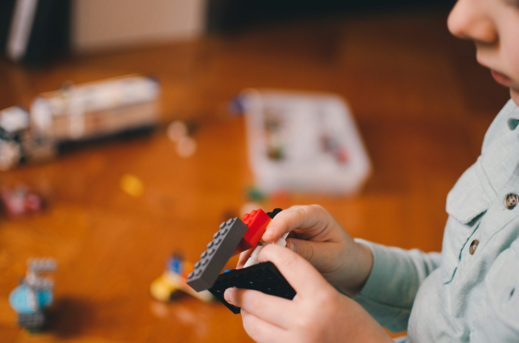 A toddler playing with building blocks