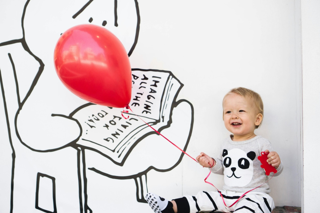 A child with a red balloon