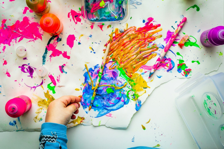 A little girl enjoying paints