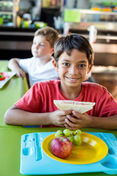 A happy boy enjoying a meal, emphasizing the role of nutritious food